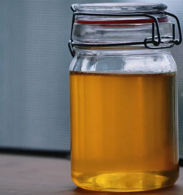 Ghee made at home and stored in a clear bottle.