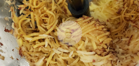 Grated potatoes in pan with ghee and jeera.